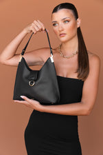 Load image into Gallery viewer, Woman&#39;s black vegan leather handbag with strap
